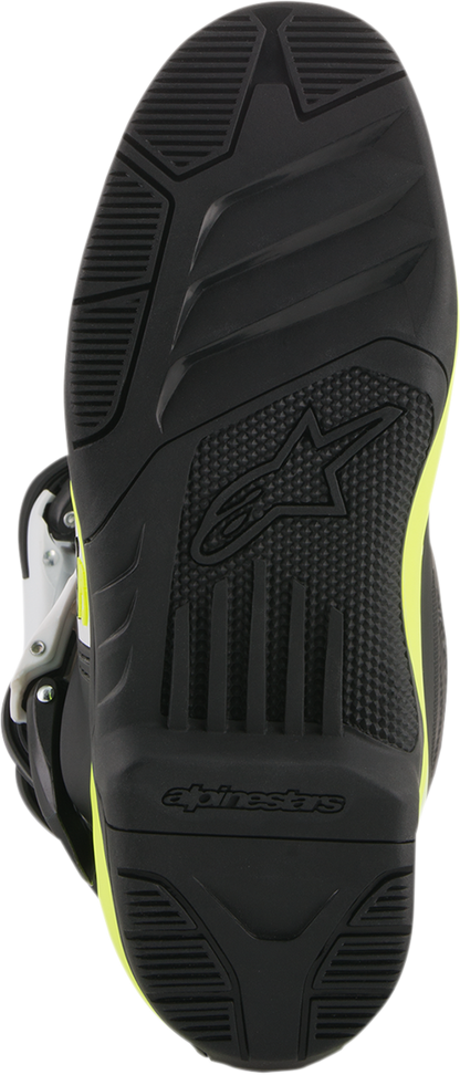Alpinestars Tech 3S motorcycle boots in black, white, and fluorescent yellow with sturdy design and adjustable straps.