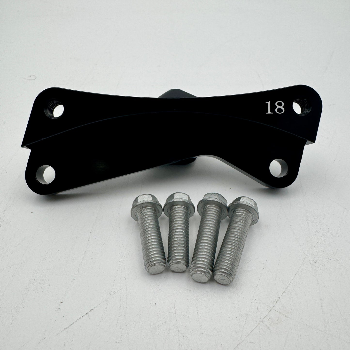 Warp9Racing Bracket 18 KX in metallic finish, showcasing its sturdy construction and precise machining for automotive use.