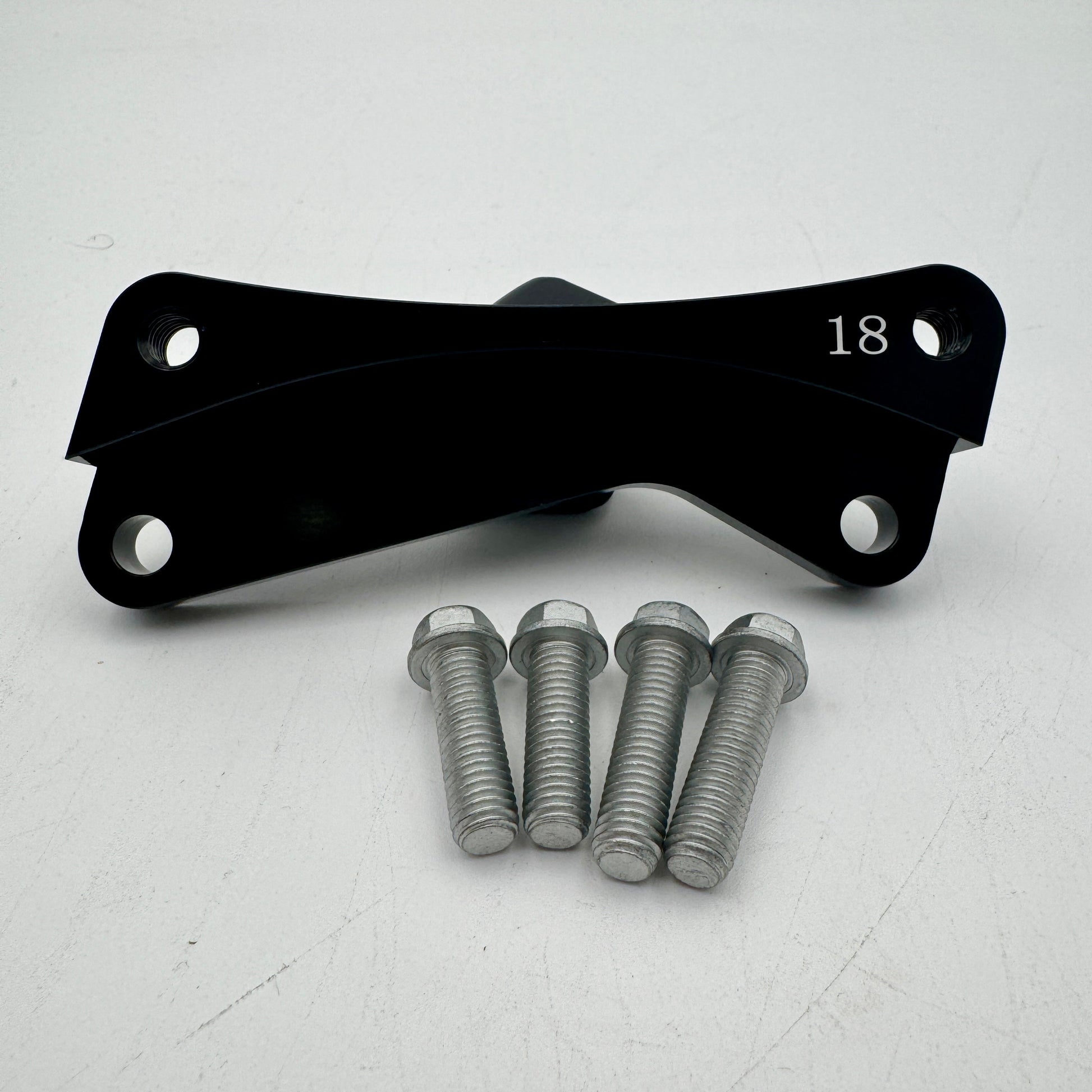 Warp9Racing Bracket 18 KX in metallic finish, showcasing its sturdy construction and precise machining for automotive use.