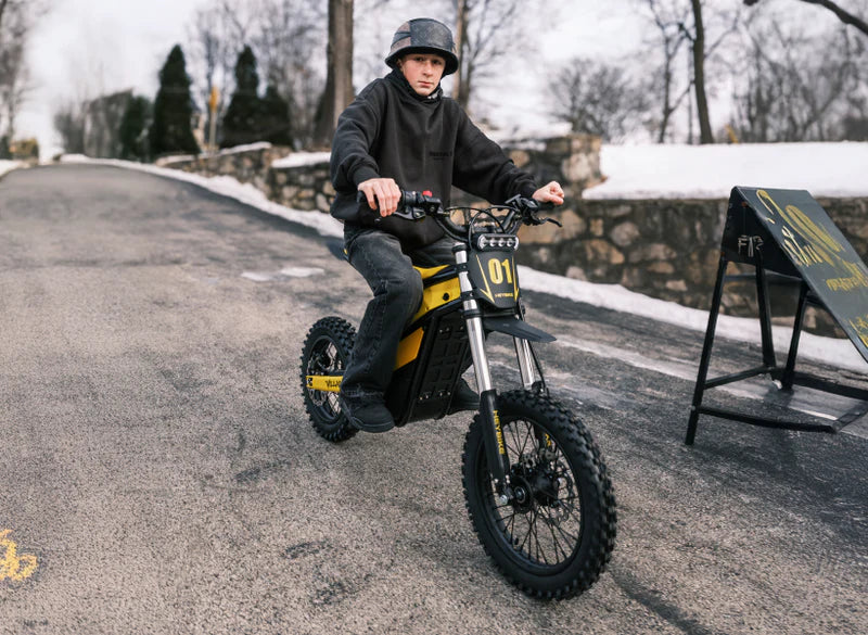 Heybike Villain electric dirt bike with mid-drive motor, black frame, knobby tires, and handlebar controls, ready for off-road riding.
