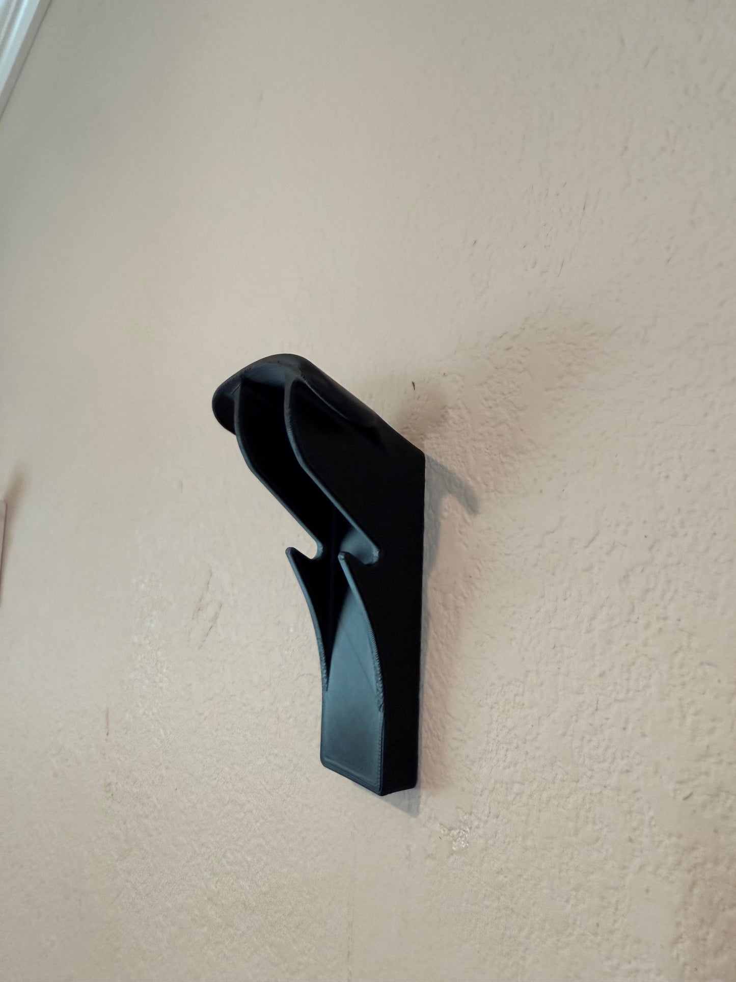 Slim-flush motorcycle helmet wall mount by McCoy Industries, showcasing a sleek, space-saving design for easy helmet storage.
