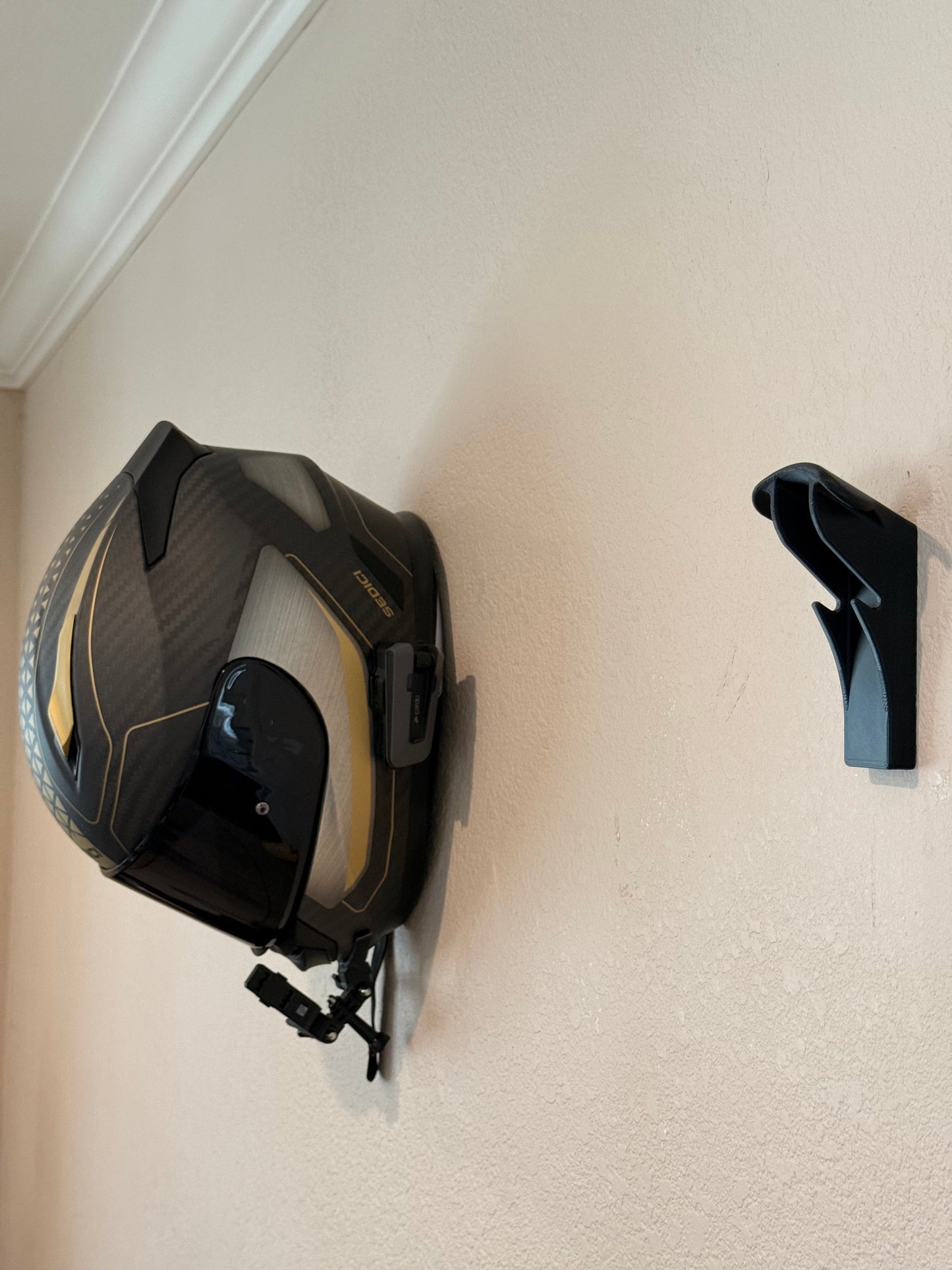 Slim Flush Motorcycle Helmet Wall Mount by McCoy Industries, showcasing a sleek wall mount for storing motorcycle helmets.