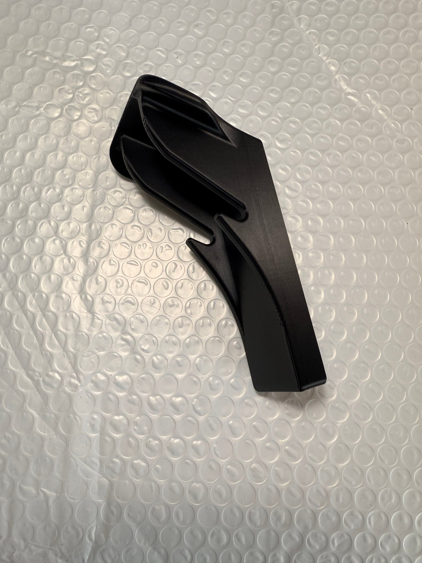 Slim-flush motorcycle helmet wall mount by McCoy Industries, designed to securely display and store helmets on the wall.