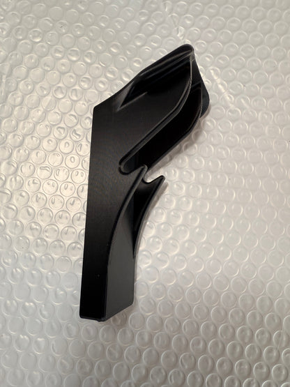Slim-flush motorcycle helmet wall mount by McCoy Industries, shown holding a helmet on a wall for secure storage and display.