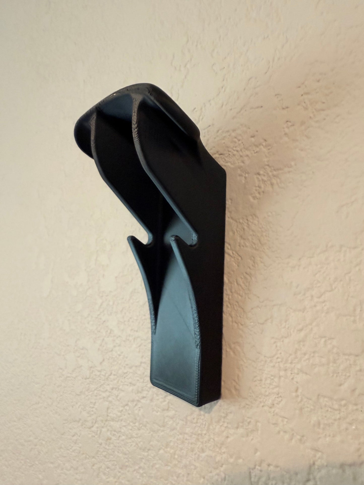 Slim-Flush Motorcycle Helmet Wall Mount by McCoy Industries, showing a sleek wall mount for motorcycle helmets on a wall.