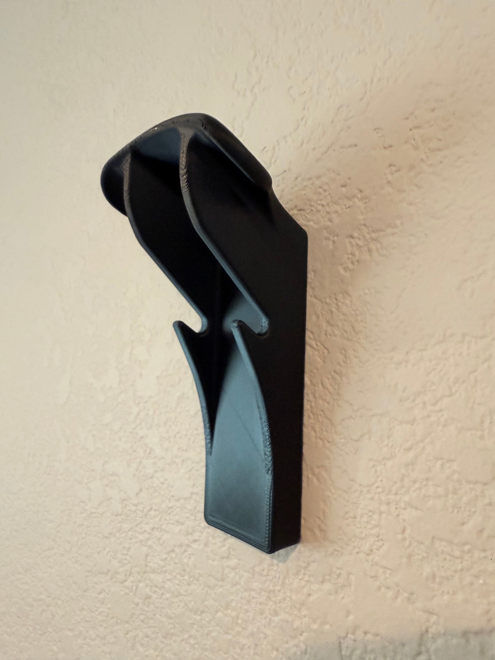 Slim-Flush Motorcycle Helmet Wall Mount by McCoy Industries, showing a sleek wall mount for motorcycle helmets on a wall.