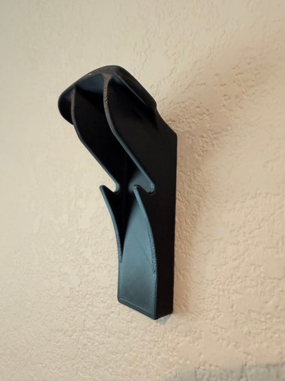Slim-Flush Motorcycle Helmet Wall Mount by McCoy Industries, showing a sleek wall mount for motorcycle helmets on a wall.