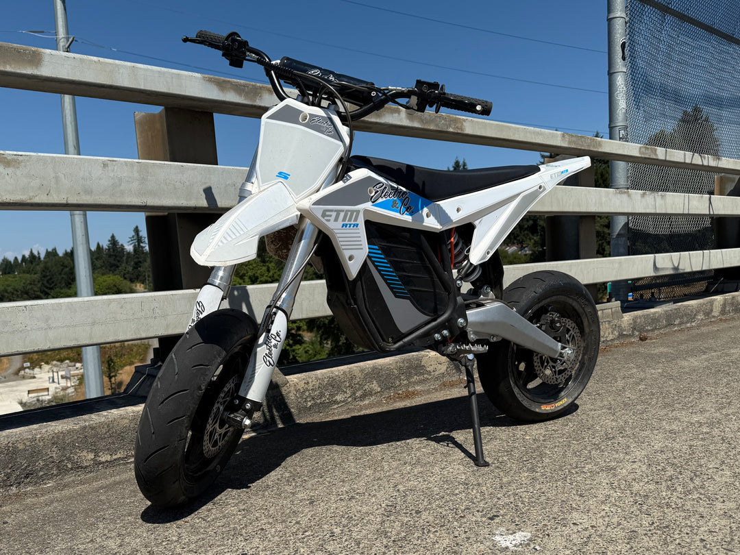Electro & Co ETM RTR 12-inch mag wheel set with Kenda tires, rotors, sprocket, and chain installed on a motorcycle.