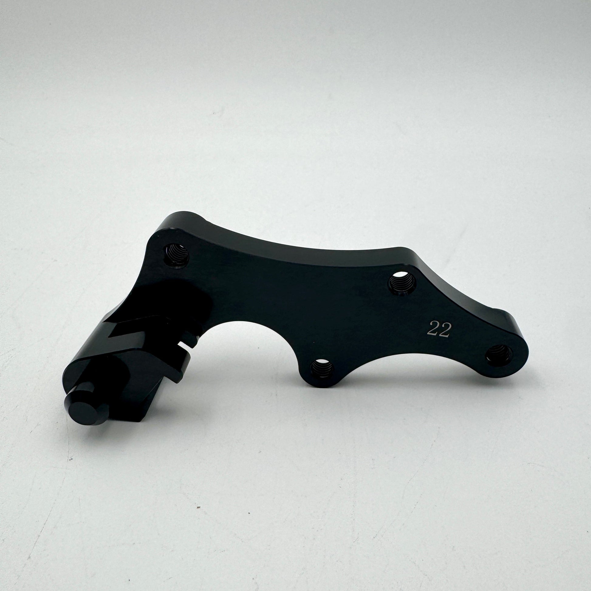 Warp9Racing Bracket 22 BETA with mounting hardware, shown in metallic finish, designed for automotive or racing applications.