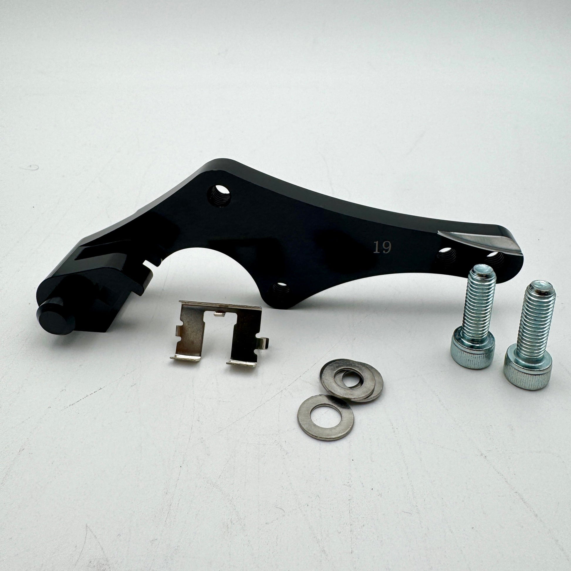 Warp9Racing bracket for KTM, Husqvarna, Gas Gas, Husaberg, Stark, and Triumph motorcycles, shown in black metal.
