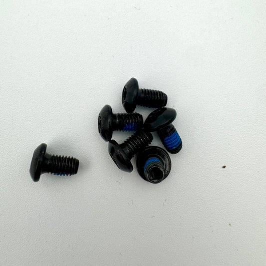 Warp9Racing M5X10-BHT Surron rotor bolt installed on motorcycle brake rotor with visible threading and bolt head.