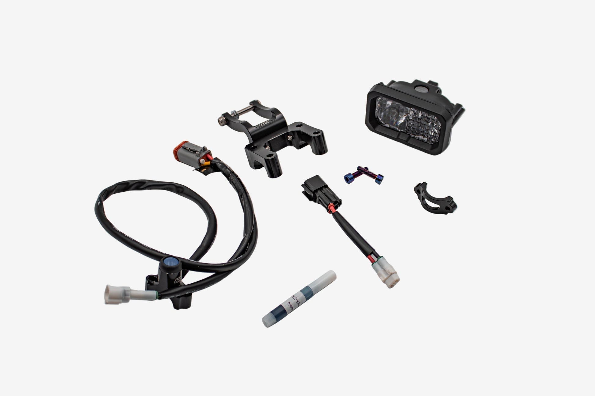 Warp9Racing V2 High-Output Headlight with W9 Mounting, showcasing a durable, high-performance motorcycle headlight with mounting hardware.