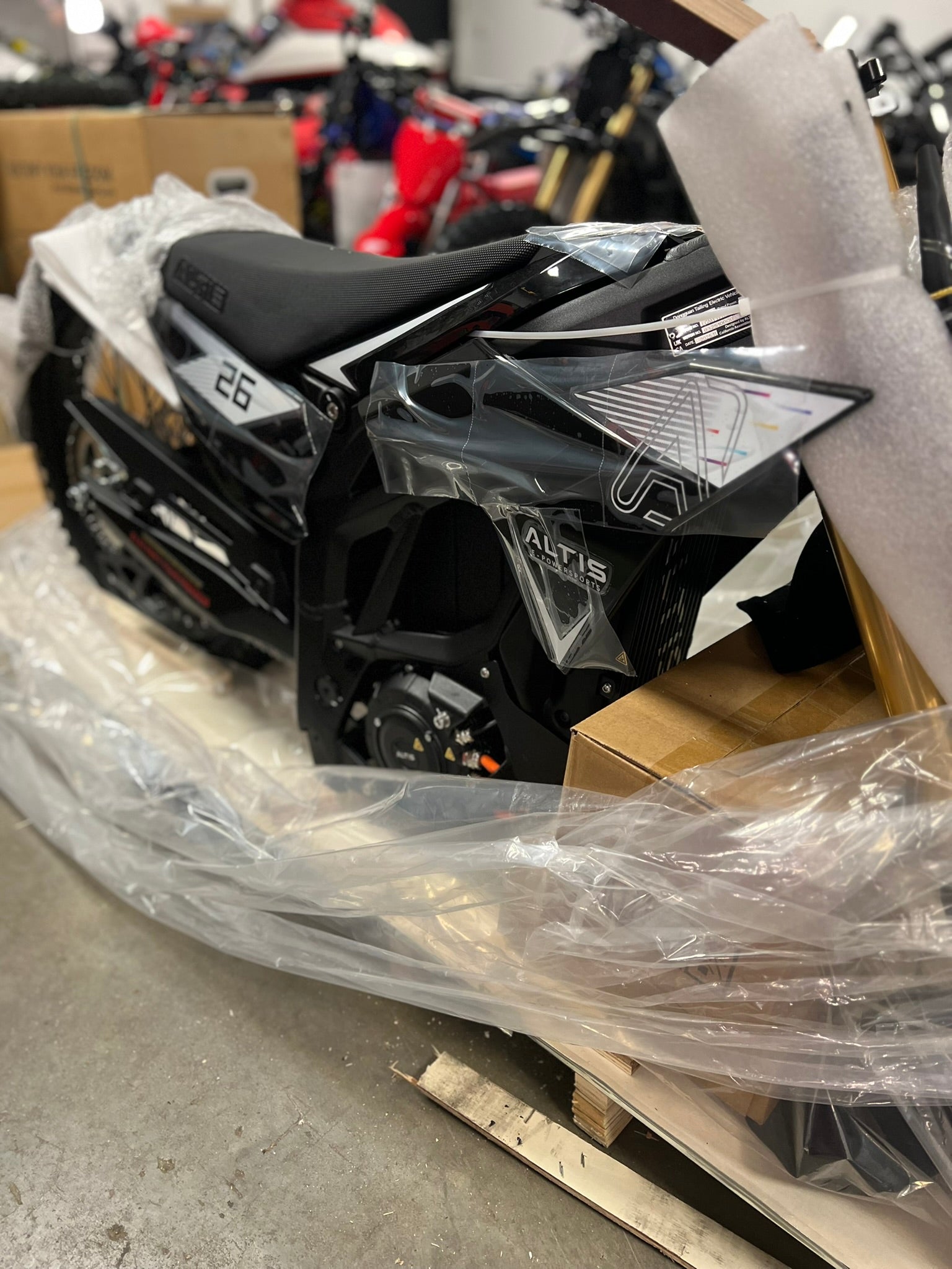 Professional e-bike assembly service by Howling Moto for the E Ride Pro Rawrr ETM Altis e-bike, showing tools and assembled components.