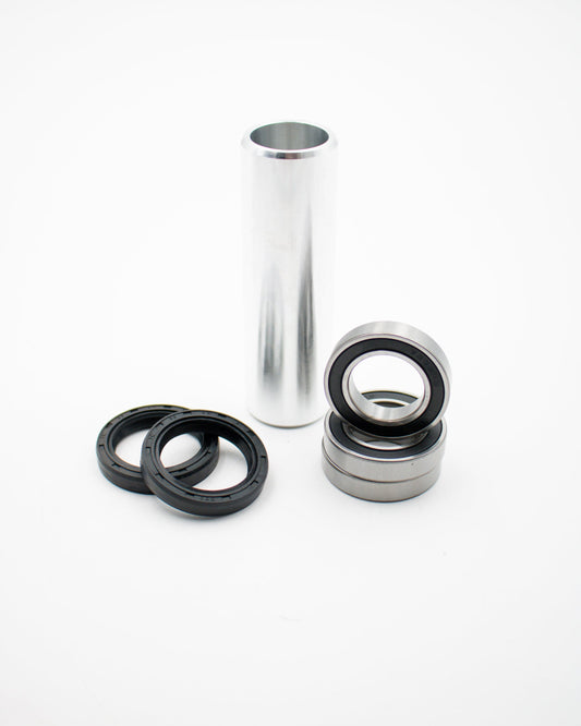 Warp9Racing Suzuki RMZ rear wheel bearing kit installed on motorcycle wheel with visible bearing and rim components.
