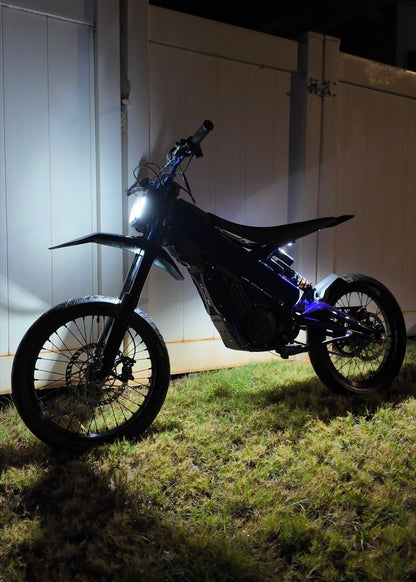 Hyperglow Surron Ultra Bee under glow kit by Project9 showing front and rear LED lighting installed on a Surron electric bike