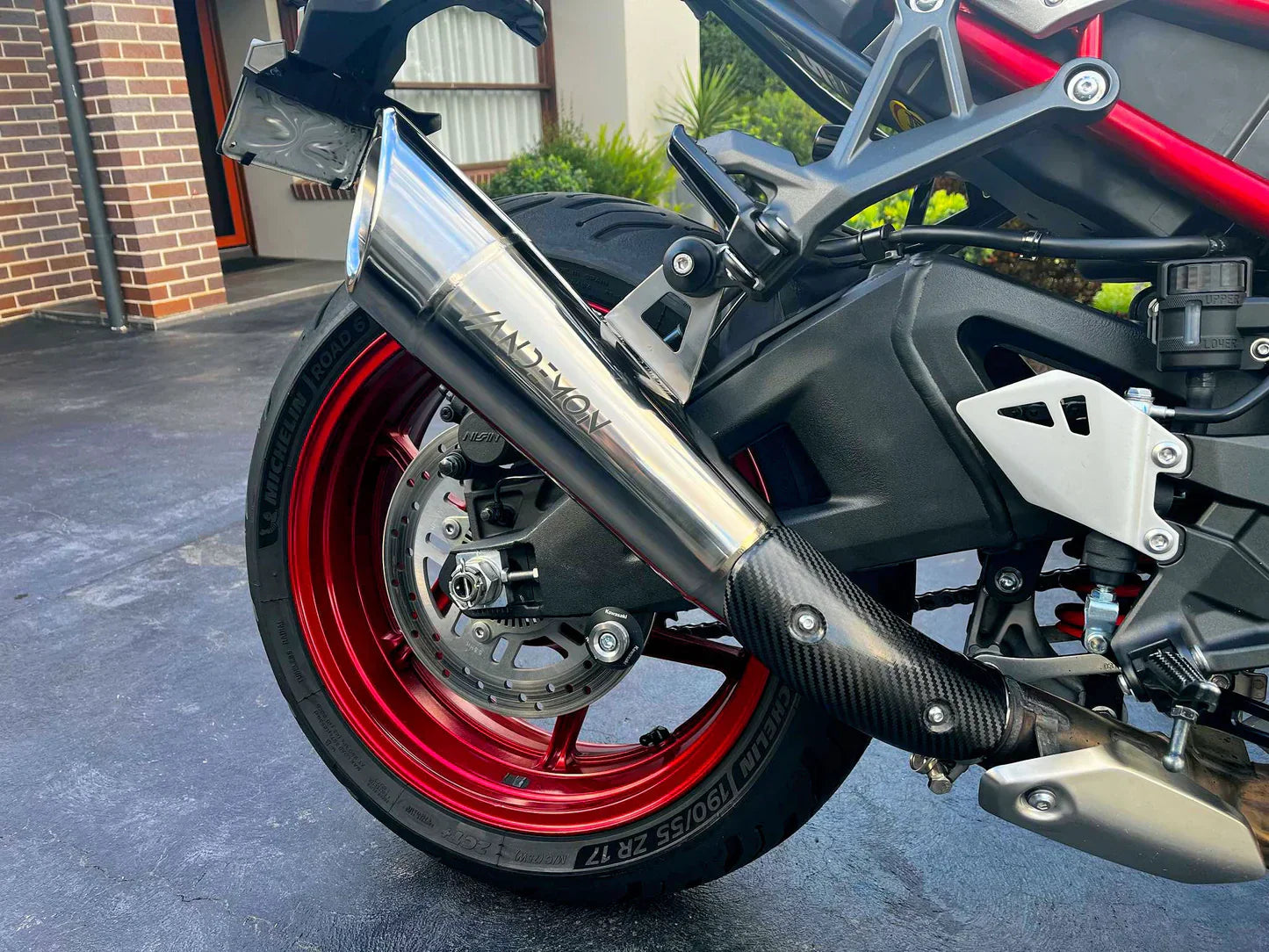 Kawasaki Ninja ZH2 H2R titanium slip-on exhaust by Bill's Exhausts, sleek stainless steel finish, mounted on motorcycle.