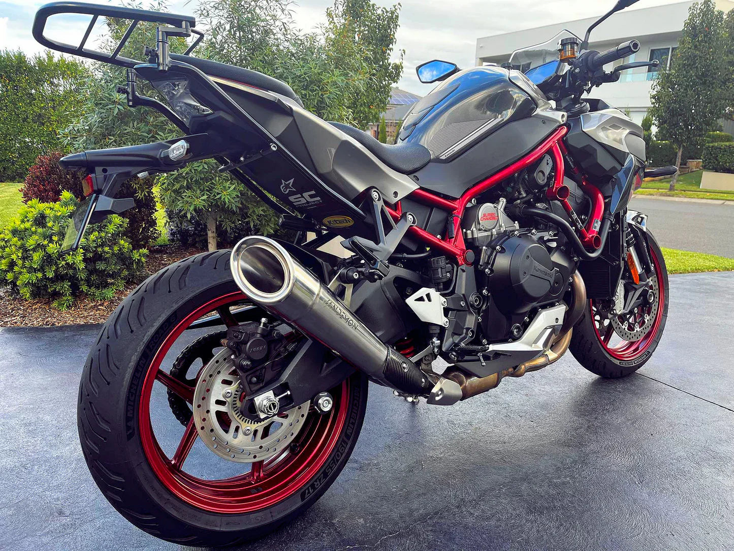 Kawasaki Ninja ZH2 titanium slip-on exhaust by Bill's Exhausts, showcasing the sleek, polished titanium finish and exhaust tip.