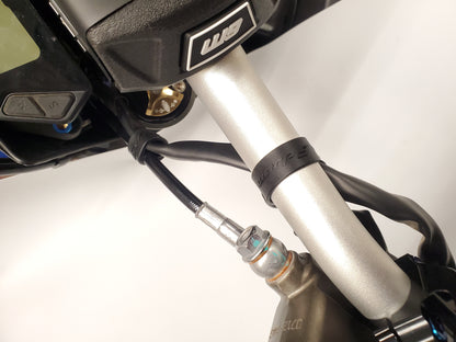 Warp9Racing Surron bar straps from Collective brand, showing durable black nylon straps with metal hardware for handlebar support.