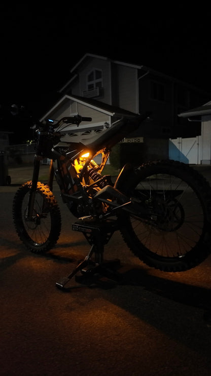 Orange rear underglow kit installed on a Sur-Ron Talaria MX4/MX5 electric dirt bike by Project9