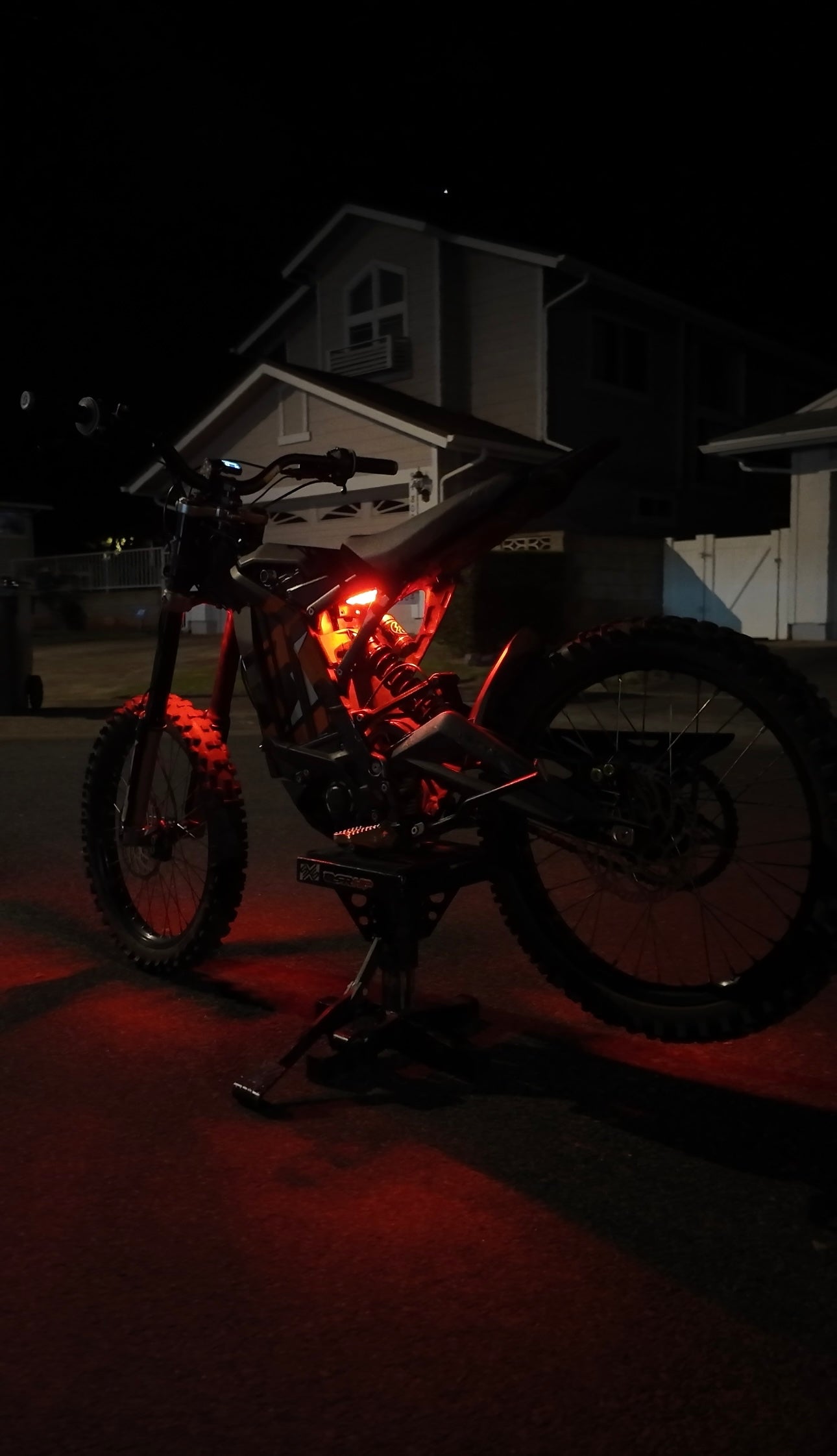 Red rear underglow kit installed on Surron Talaria MX4/MX5 e-bike by Project9, showcasing vibrant LED lighting at the back.