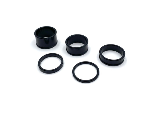 Warp9Racing Stem Lock Spacer Kit with black spacers for bicycle handlebars and stem assembly.