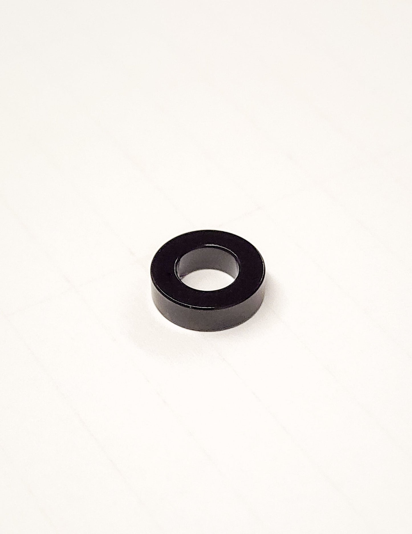 Warp9Racing Ultra Bee Seat Spacer for bike seat adjustment, showing the black spacer with mounting hardware.