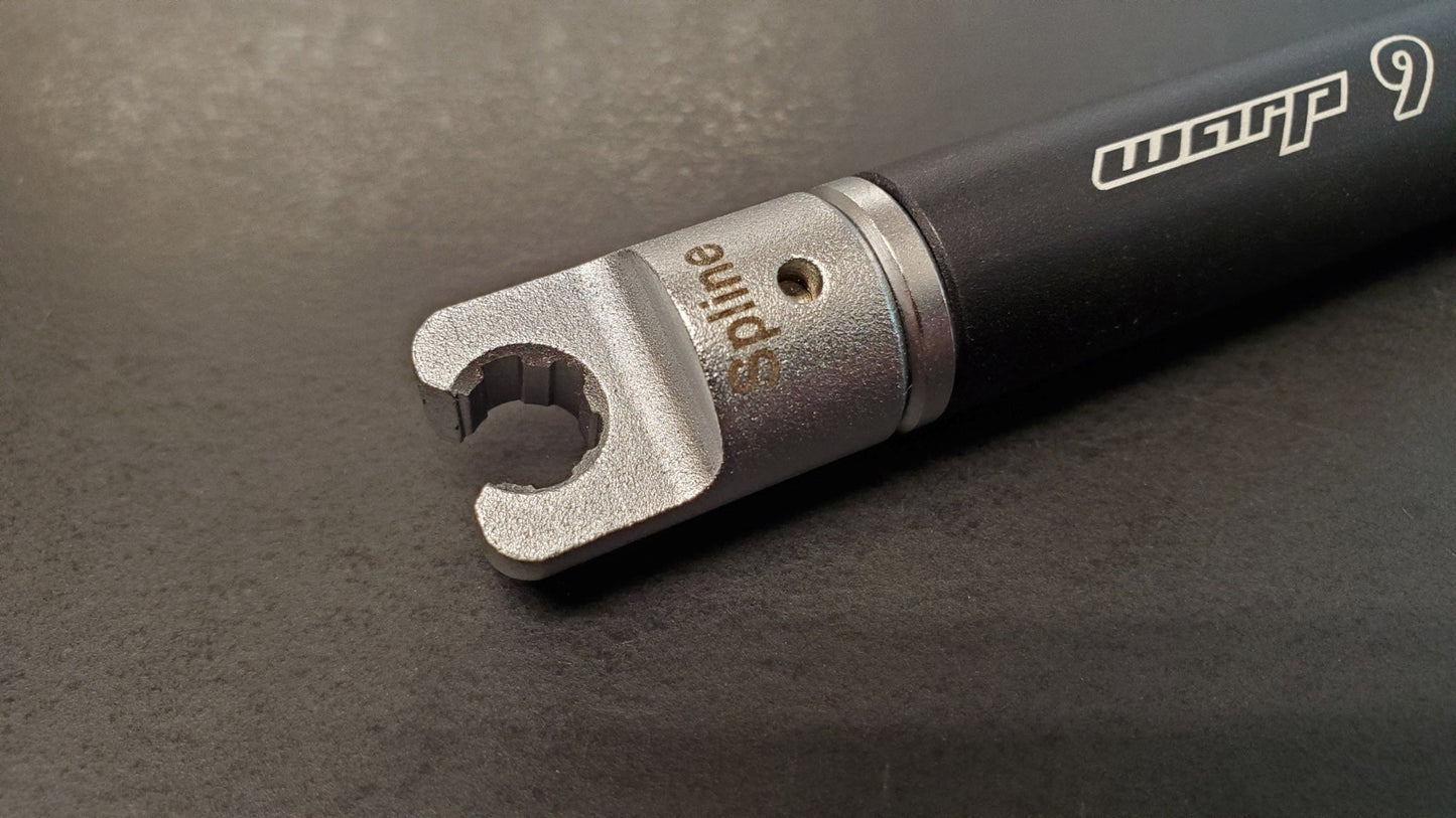 Warp9Racing spline tip spoke wrench for bike wheel adjustments, featuring adjustable design and durable metal construction.