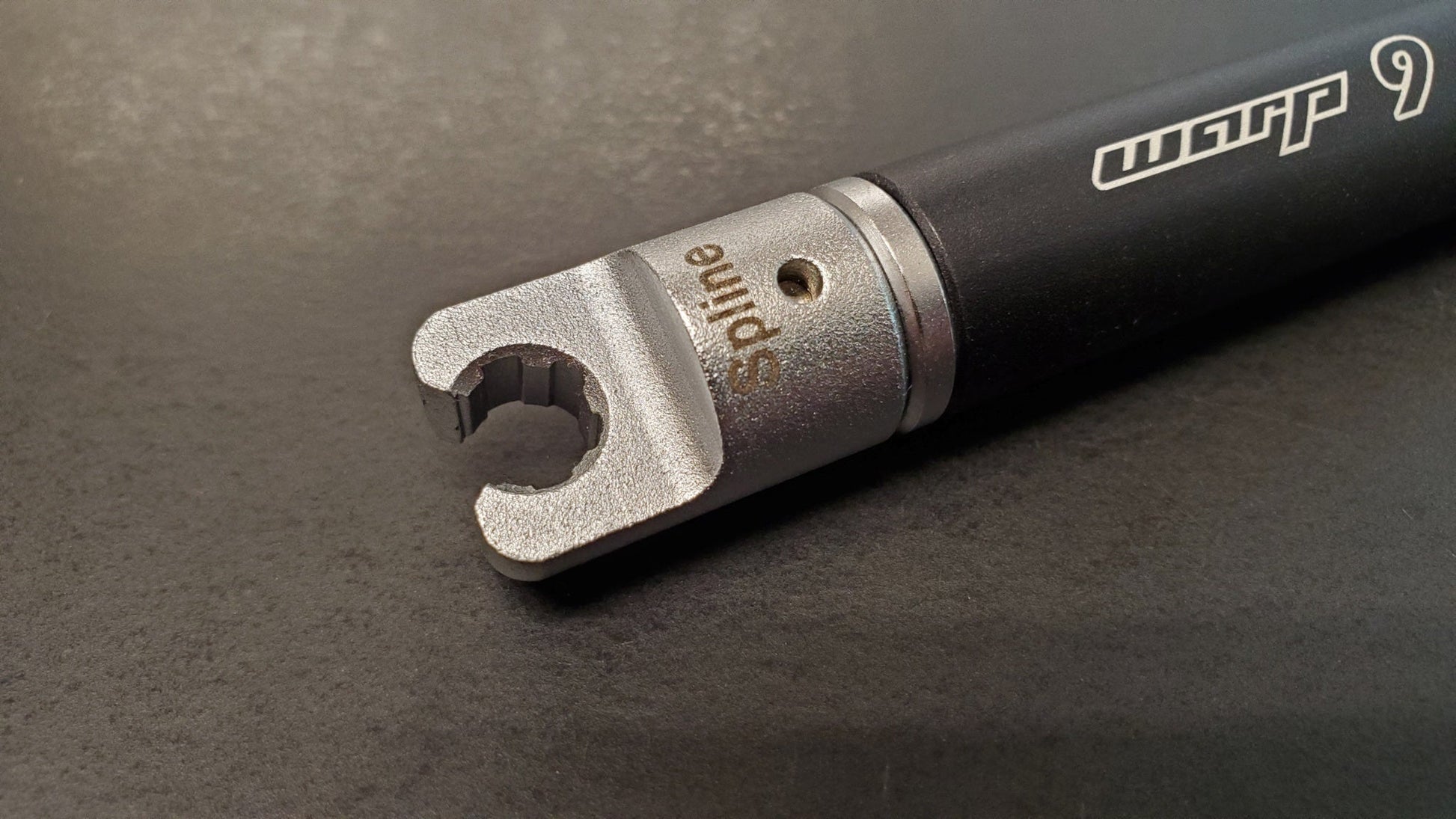 Warp9Racing spline tip spoke wrench for bike wheel adjustments, featuring adjustable design and durable metal construction.
