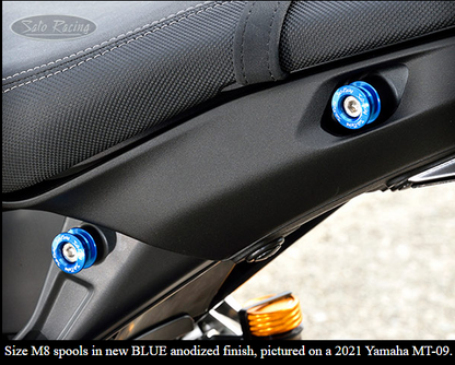 Sato Racing M6/M8 anodized aluminum motorcycle cargo tie-down spools for secure bike transportation and accessories.