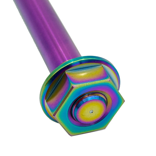 Close-up of eDirtyBike titanium intermediate shaft axle for Surron LBX electric bike, showing rainbow finish and detailed machining.