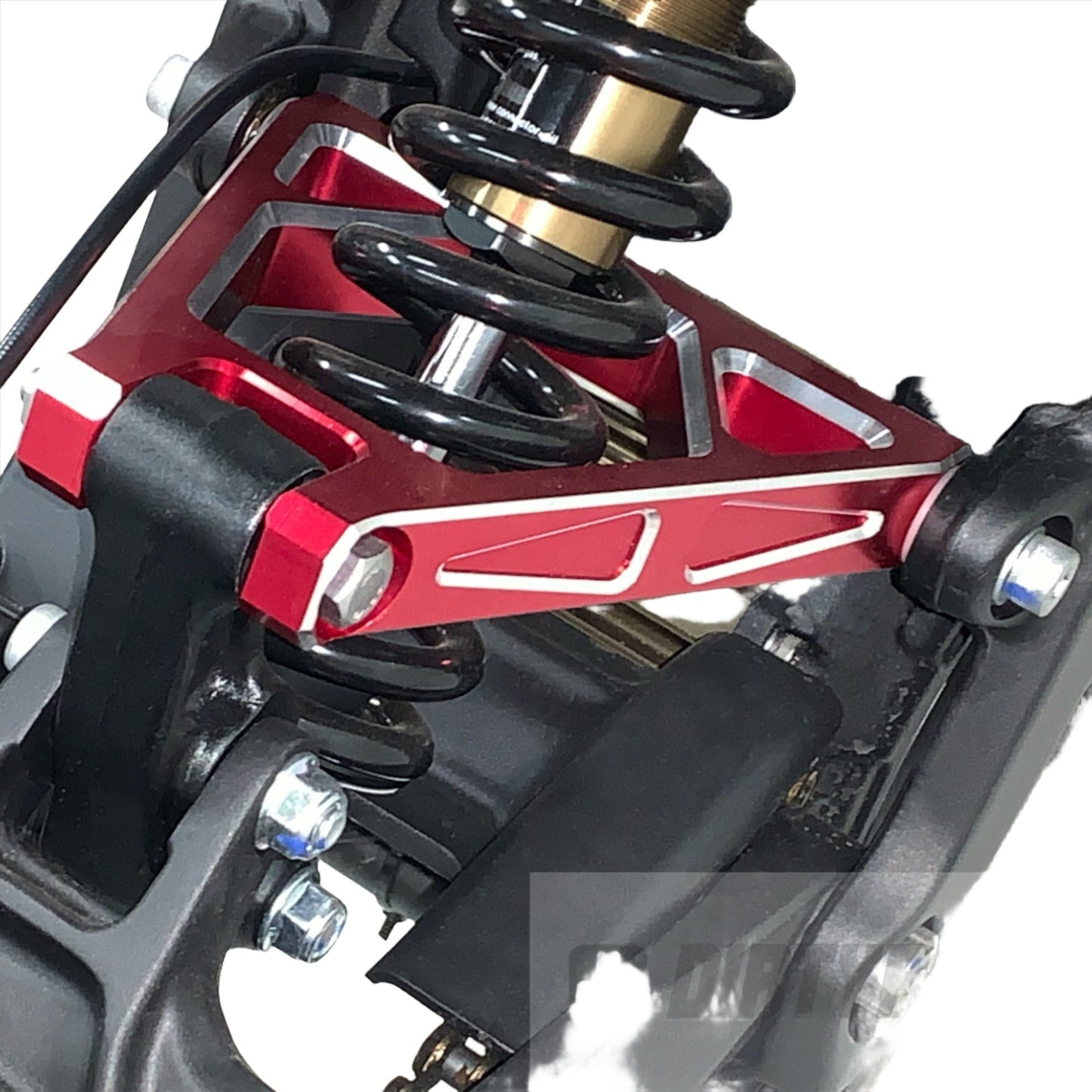 Red aluminum suspension triangle on a Surron Light Bee LBX electric bike, showcasing the eDirtyBike suspension component.