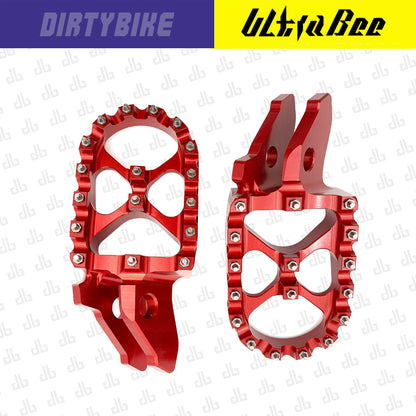 Red aluminum CNC foot pegs for Sur-Ron Ultra Bee eBike by eDirtyBike, heavy-duty design for durability and secure rider footing.