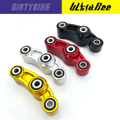 CNC aluminum suspension linkage for Surron Ultra Bee electric bike by eDirtyBike, featuring colorful finish and precise design.