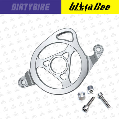 CNC aluminum motor sprocket cover for Surron Ultra Bee electric bike by eDirtyBike, with sleek silver finish and precise fit.