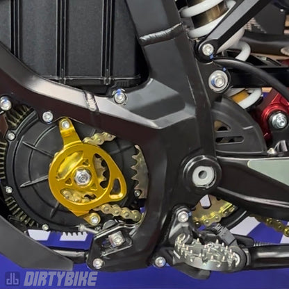 CNC aluminum motor sprocket cover on a Surron Ultra Bee electric bike, showcasing durable black finish and precise fit.