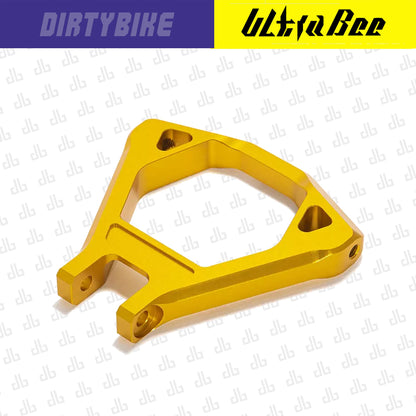 Gold CNC aluminum suspension triangle for Surron Ultra Bee electric bike by eDirtyBike, showcasing sleek lightweight design.