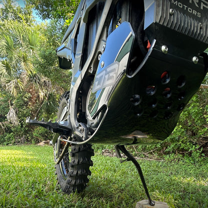 Surron Ultra Bee eDirtyBike skid plate installed on bike, showing durable protective metal part for off-road riding.