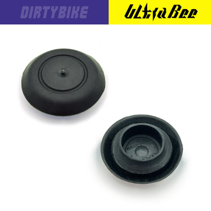 Close-up of eDirtyBike Hard Enduro Skid Plate Mud Plugs on a Surron Ultra Bee electric bike, showing durable protective parts.
