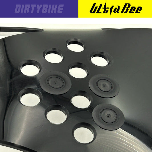 eDirtyBike Hard Enduro skid plate with mud plugs installed on a Surron Ultra Bee electric bike, showing the durable protective component.