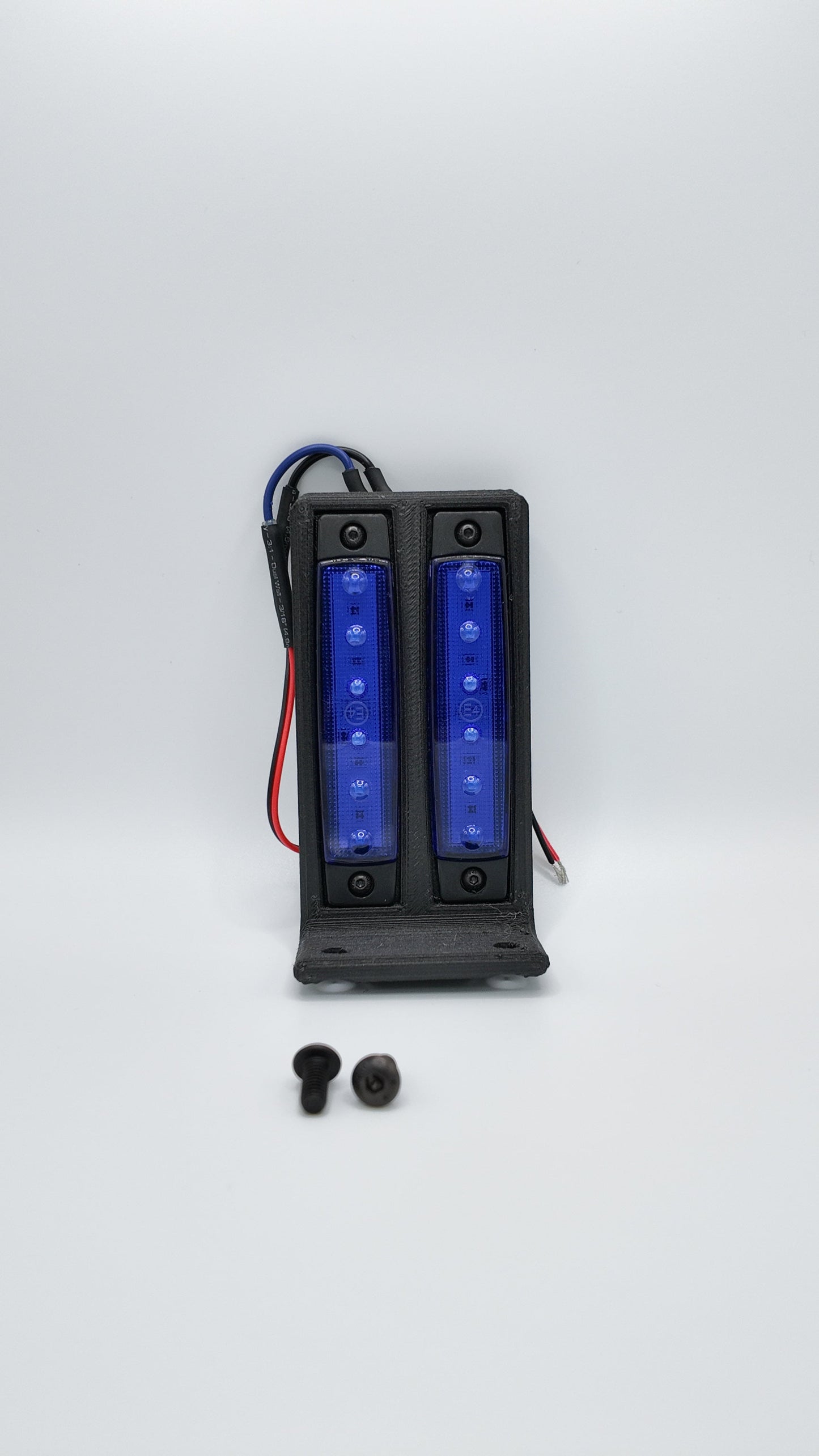 Surron under glow kit from Project9 featuring colorful LED lights installed on a Surron electric bike's rear underside.