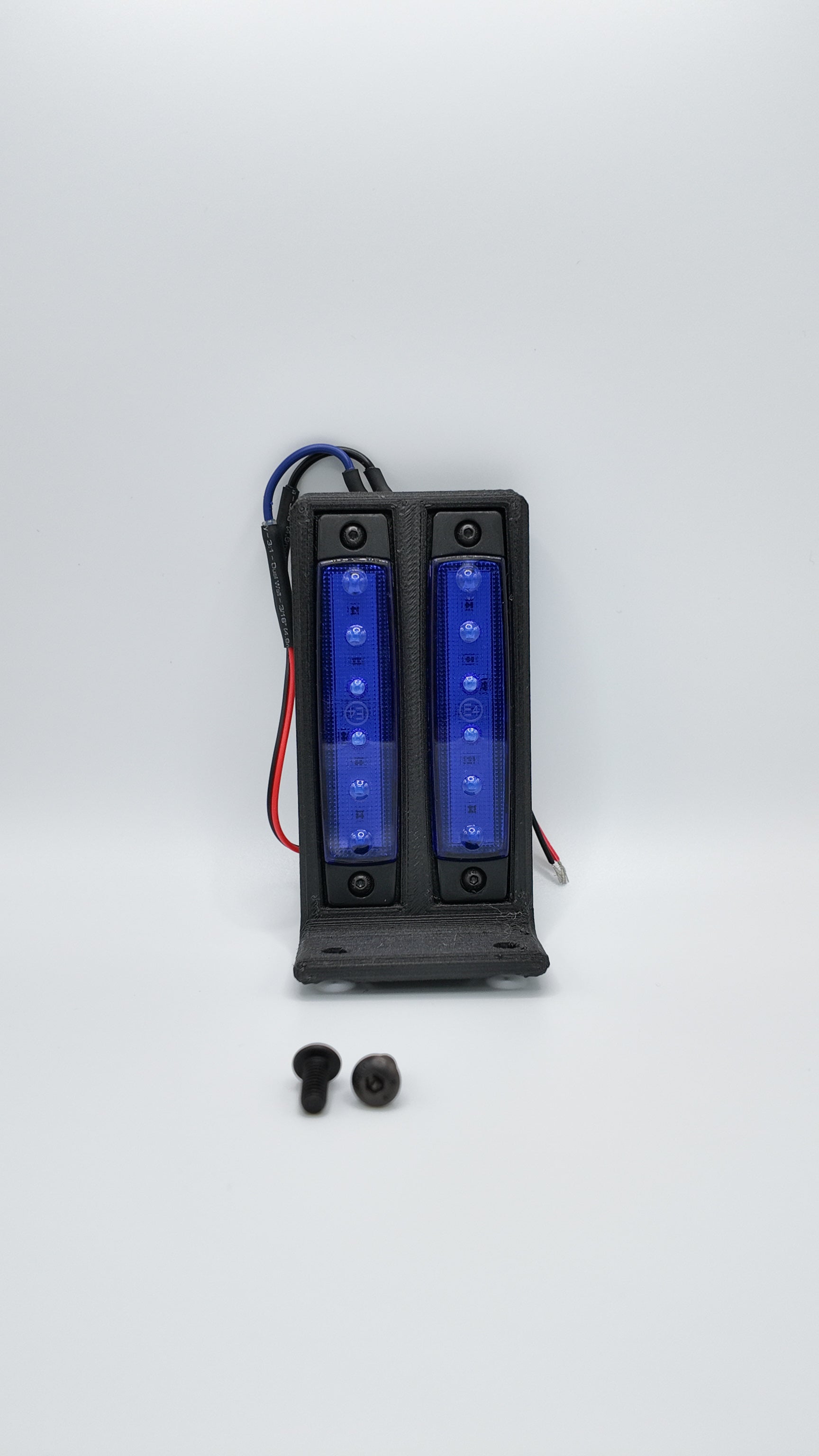 Surron under glow kit from Project9 featuring colorful LED lights installed on a Surron electric bike's rear underside.