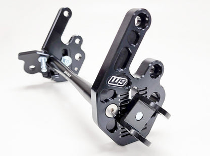 Warp9Racing Sur-ron LBX and 79Bike adjustable foot peg mount, black metal with mounting hardware visible for enhanced rider comfort.