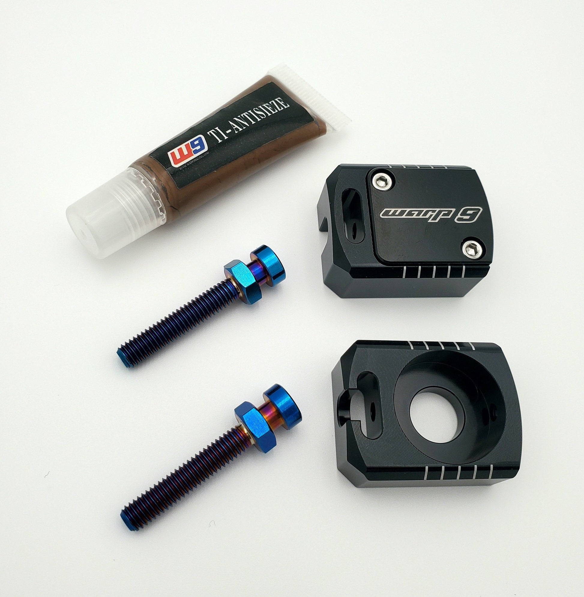 Warp 9 Racing Lockdown Axle Blocks for Sur-Ron Light Bee, titanium captive adjustment, shown in steel finish on the bike.