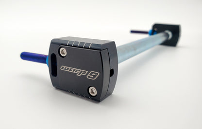 Warp 9 Racing Lockdown Axle Blocks for Sur-Ron Light Bee, titanium captive adjustment, shown on steel axle in detailed view.