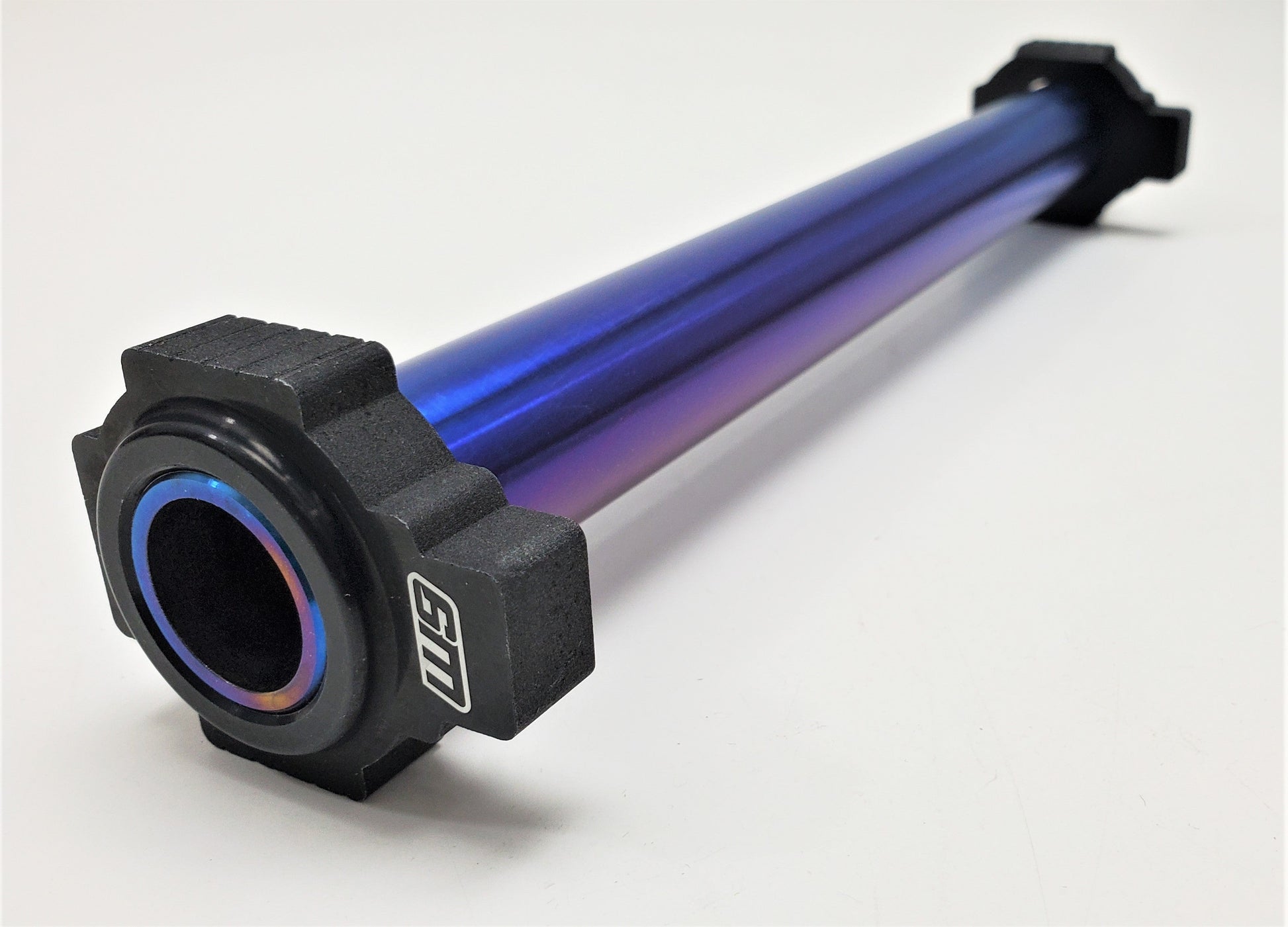 Warp9Racing titanium rear axle for KTM motorcycles, showcasing a durable, lightweight metal component with a polished finish.