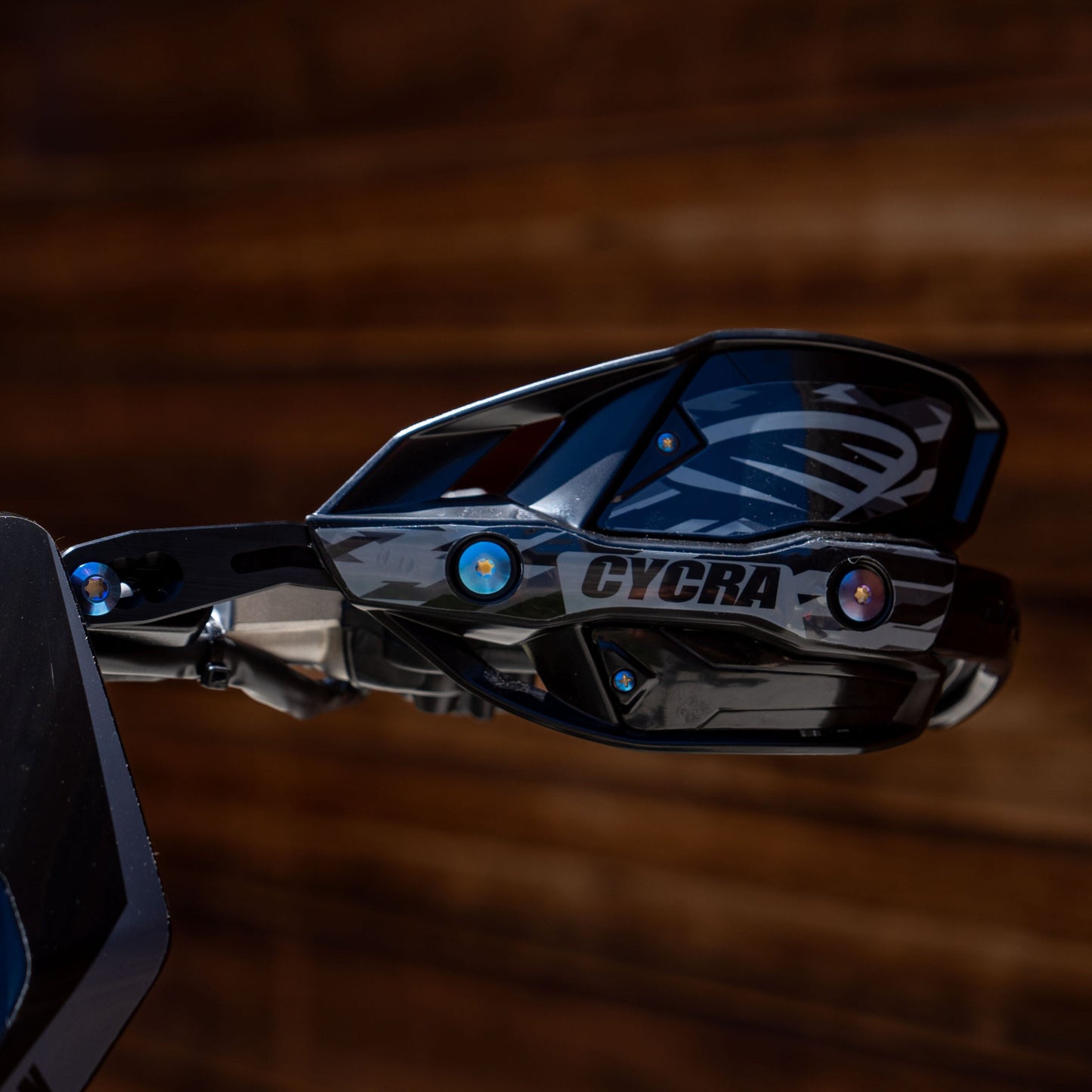 Cycra Titanium Bolt Kit by Warp9Racing, featuring lightweight durable titanium bolts for motorcycle parts, shown in a close-up image.