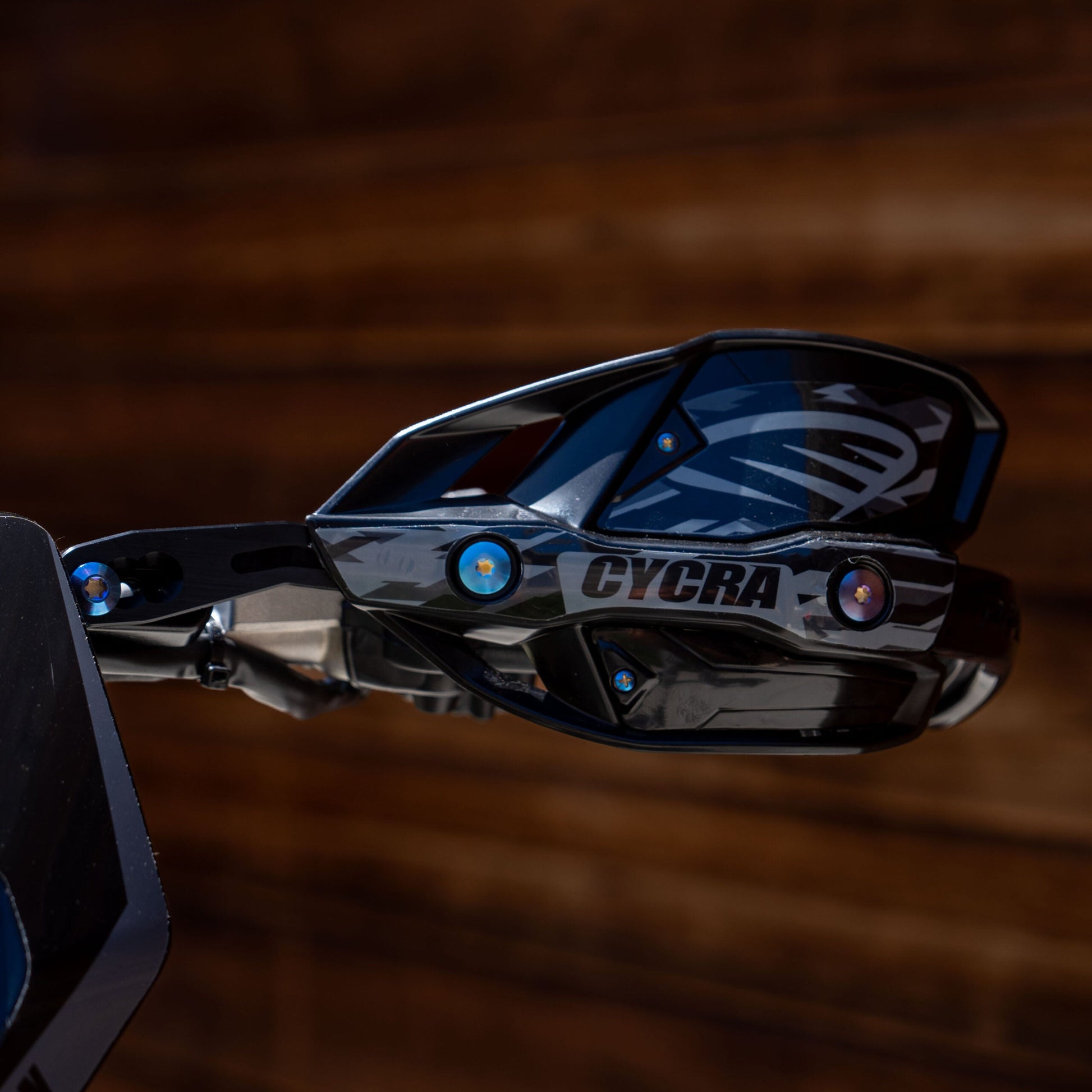 Cycra Titanium Bolt Kit by Warp9Racing, featuring lightweight durable titanium bolts for motorcycle parts, shown in a close-up image.
