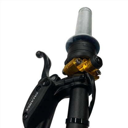 Gold 1/4 turn electronic throttle kit from eDirtyBike on Talaria Sting MX3 dirt bike, with start button visible.