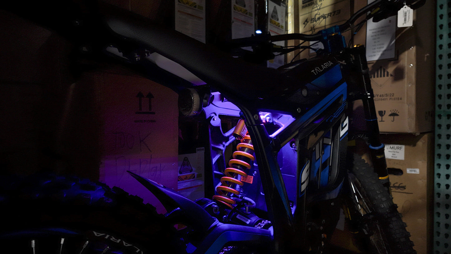 Purple rear underglow kit for Talaria MX4 and MX5 electric motorcycles by Project9, showcasing vibrant LED lighting on the bike.