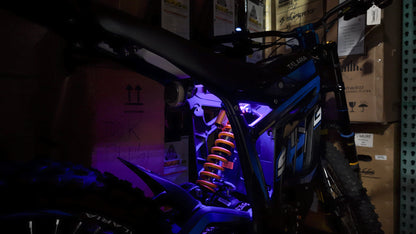 Purple rear underglow kit for Talaria MX4 and MX5 electric motorcycles by Project9, showcasing vibrant LED lighting on the bike.
